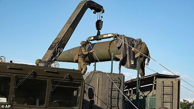 Russian troops load an Iskander missile as part of exercises to train the military in the use of tactical nuclear weapons at an undisclosed location in Russia.