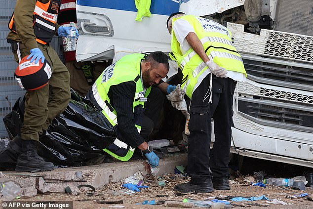 Israeli emergency services clear the scene after a driver plowed his truck into a crowd of people at a bus stop in Ramat Hasharon, north of Tel Aviv, on October 27, 2024.