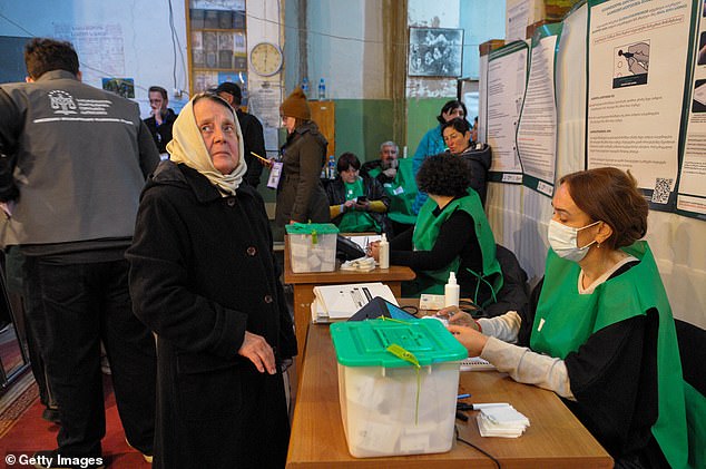 Georgian citizens participate during the parliamentary elections on October 26, 2024 in Tbilisi, Georgia.