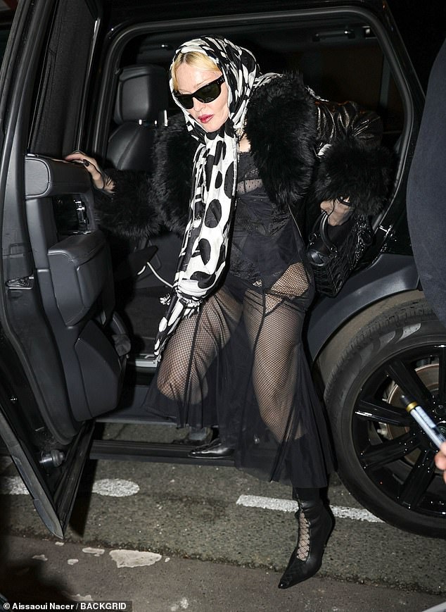 Madonna elevated her figure in a pair of knee-high black lace-up boots and carried her belongings in a matching bag.