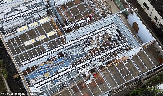 Aerial photographs taken in July showed the roof torn off revealing debris piled in rooms inside.