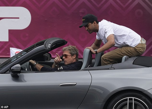 Brad was seen in a metallic gray sports car during the drivers' parade.