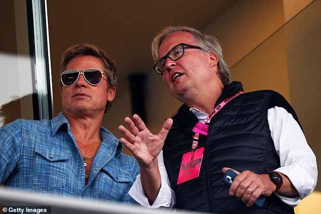 Brad Pitt chats with another VIP at the F1 Mexican Grand Prix on Sunday