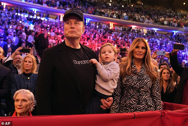 Musk holds his son and stands next to former first lady Melania Trump, who took the stage in a stunning appearance.