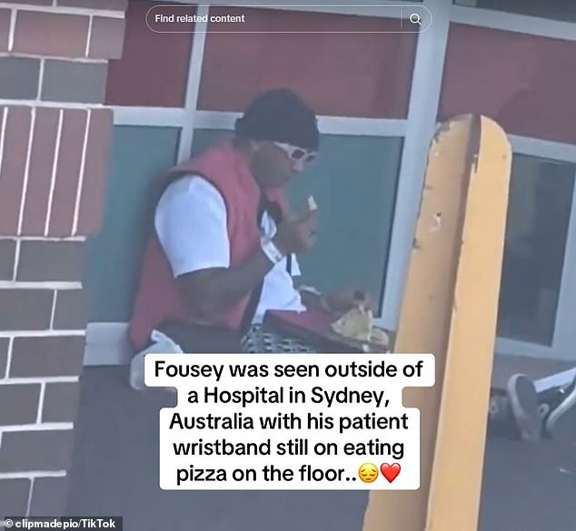 Fousey was later seen sitting on the floor outside Liverpool Hospital eating pizza.