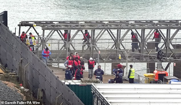 A group of people believed to be migrants are taken to Dover, Kent, from a Border Force ship following an incident with a small boat in the English Channel on October 15, 2024.