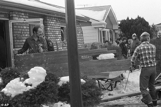 Cook County sheriff's deputies conduct a section of the floor of Gacy's Illinois home in 1978 while searching for bodies. They found 26 under the house