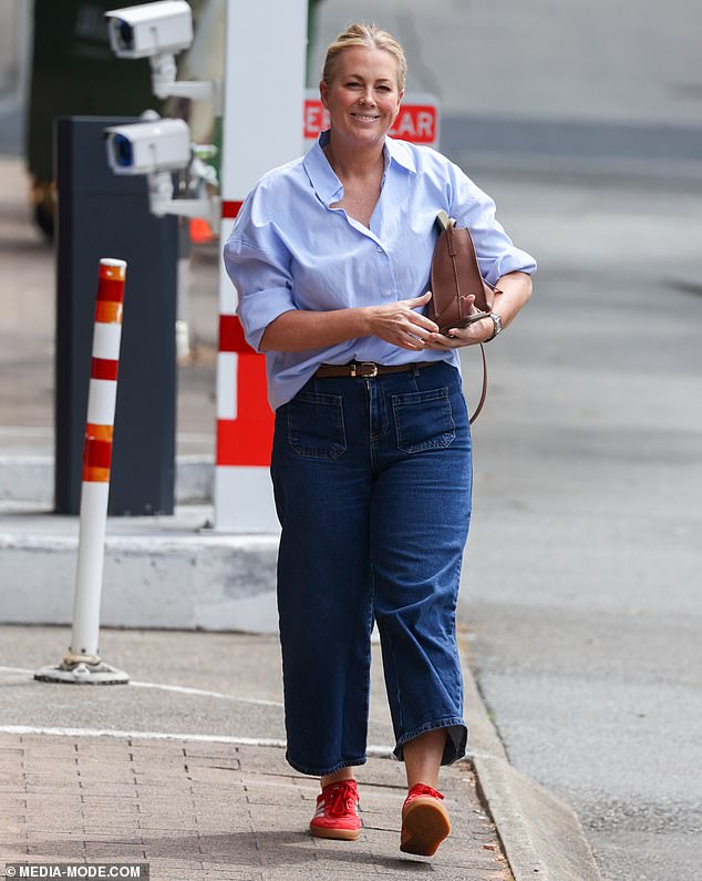 She finished her ensemble with a pair of red Adidas Sambas to add a touch of street style to her look.