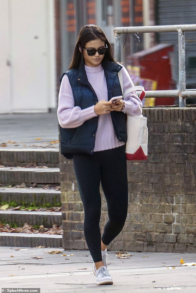 The tennis star dressed in a lilac sweater for the outing, which she paired with a navy vest and black leggings.