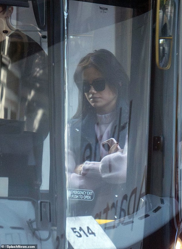 Emma waited patiently for her turn as she boarded the bus.