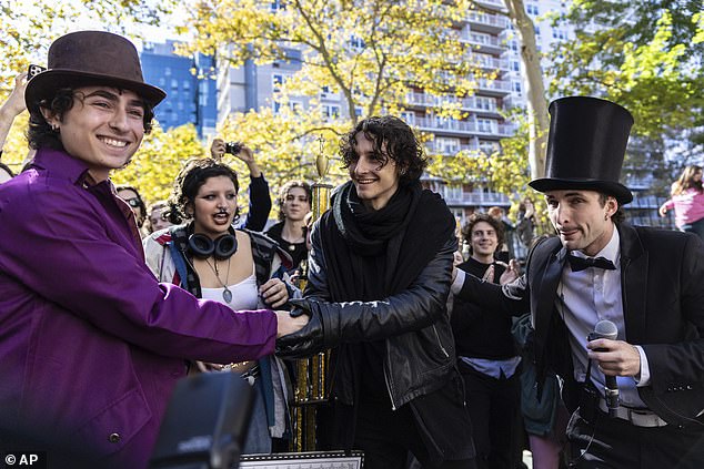 Finalists Miles Mitchell (left) and Zander Dueve (center) shake hands in the Timothee Chalamet impersonator contest.