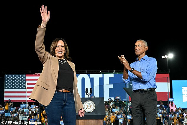 Former US President Barack Obama applauds US Vice President and Democratic presidential candidate Kamala Harris during a campaign rally at James R Hallford Stadium in Clarkston, Georgia.