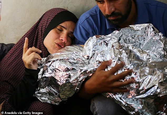 Palestinian boy, who lost his life in a recent attack by the Israeli army in the Bureij refugee camp, Mohammed al Dahdouh's relatives express their grief at the Al Aqsa Martyrs Hospital in Deir al-Balah, Gaza, on 28 October 2024