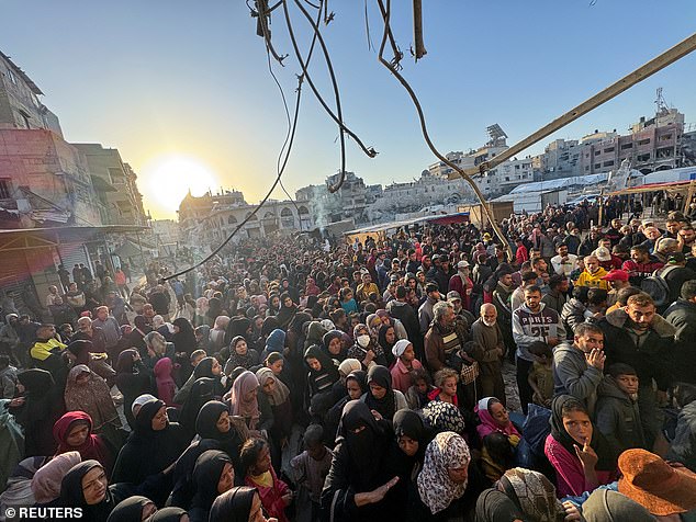 Palestinians gather to buy bread at a bakery, amid the conflict between Israel and Hamas, in Khan Younis, in the southern Gaza Strip, on October 28, 2024.