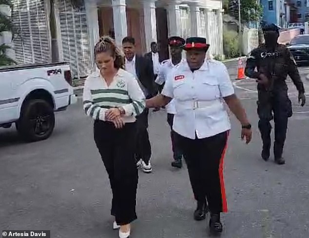 Footage obtained by DailyMail.com shows the blonde housewife being taken to the infamous Fox Hill Prison, one of the grimmest prisons in the Caribbean region.