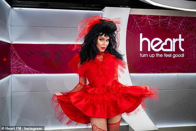 Amanda dressed as the character Lydia, with a spectacular black wig and a red tulle dress.