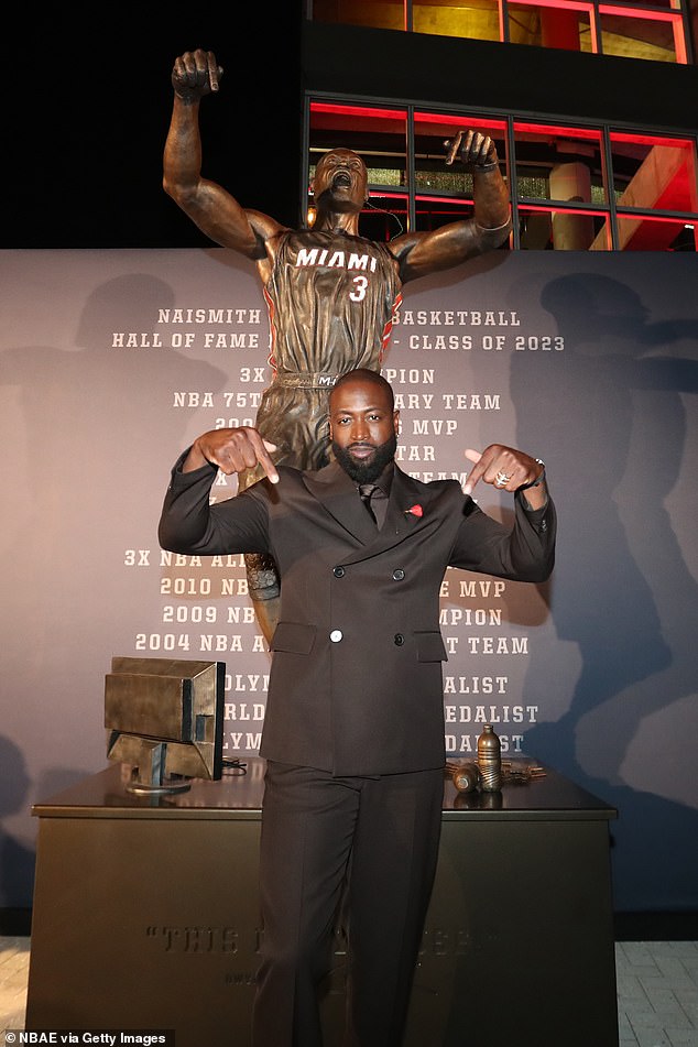 Wade poses next to his statue after Sunday's dedication ceremony in front of the Kaseya Center.