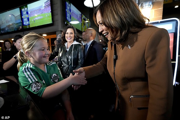 Harris also greeted people at the bar like this young woman pictured above.