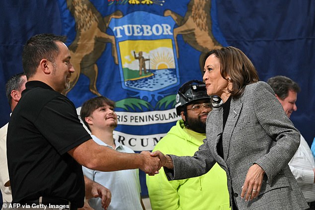 U.S. Vice President and Democratic presidential candidate Kamala Harris greets union workers as she tours an International Union of Painters and Allied Trades training center in Macomb, Michigan, on October 28, 2024.