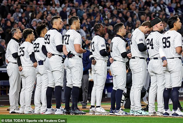 Yankees players line up to sing the national anthem before Game 3 of the World Series