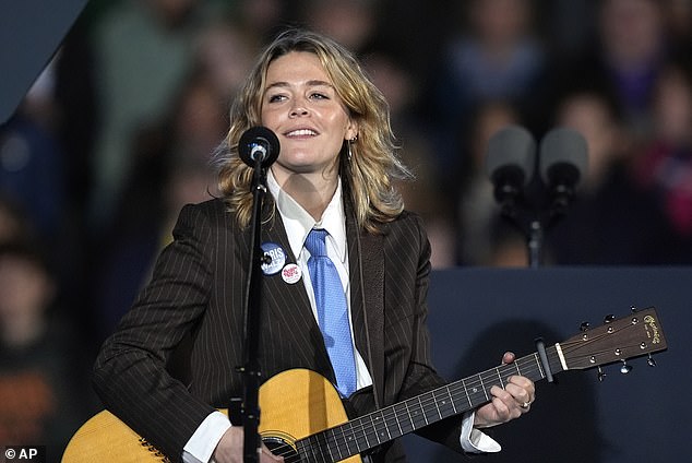 Rogers sang several songs, including 'Light On,' at the rally. He also sported a Harris-Walz pin and a blue tie.