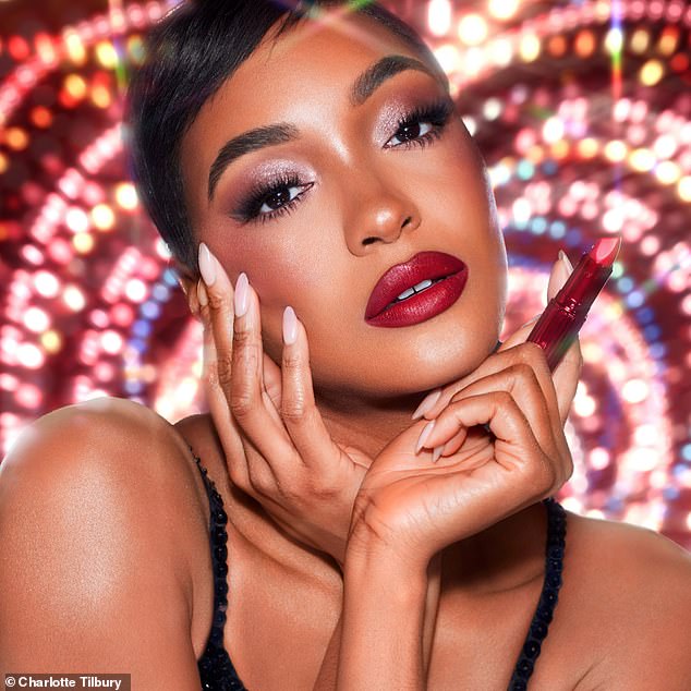 Jourdan Dunn exuded glamor as she painted her signature pout with bright red lipstick.