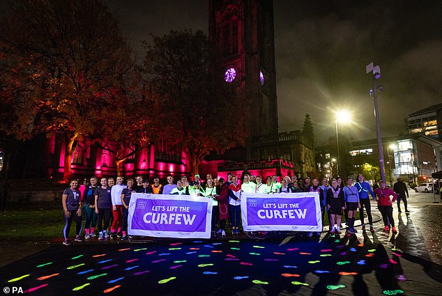 Runners take part in This Girl Can's Let's Lift the Curfew event in Manchester, after new research found almost three quarters of women adjust their behavior when exercising outdoors during the winter months.