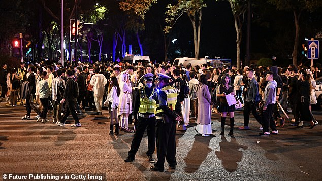 Last year, partygoers gathered in the streets where there was also a police presence. Pictured: Citizens and tourists dress up and participate in a Halloween parade in Shanghai, China, on October 31, 2023.