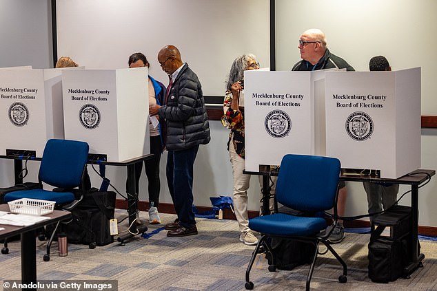 A record 2.8 million people in North Carolina (above) have cast early ballots, and tens of thousands of those votes came from the storm-ravaged West.