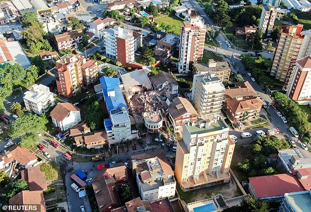 Spectacular aerial images show a pile of rubble where the building stood among other high-rise blocks.