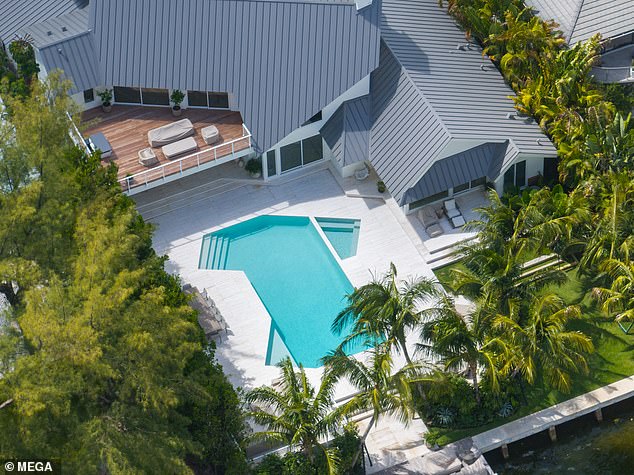 The home has five bedrooms and seven bathrooms and sits on a massive 18,400 square foot lot. Outside, there is a huge swimming pool with an adjacent hot tub.