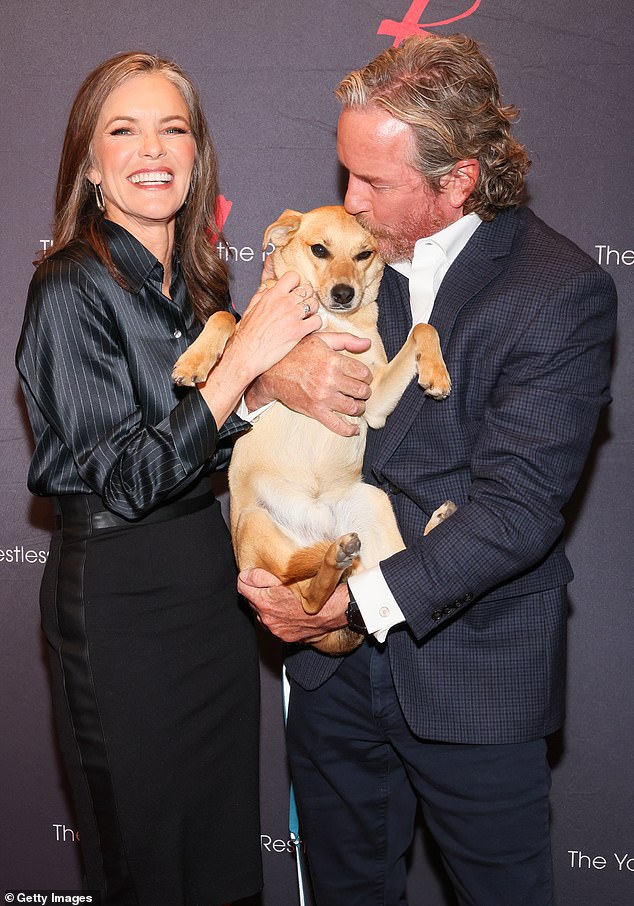 Susan is seen with her beautiful puppy Frito and her husband since 1986 Linden Ashby.