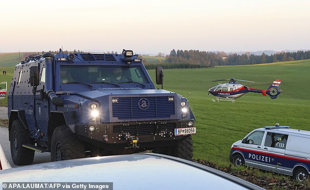 Police officers patrol near Rohrbach, Upper Austria, on October 28, 2024, during the chase for a gunman suspected of killing a local mayor and another person.