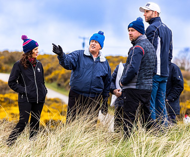 Donald (centre) and Eric Trump (far right) talk to staff during work at Trump International Golf Links in Aberdeenshire, Scotland. The business position allows Eric 