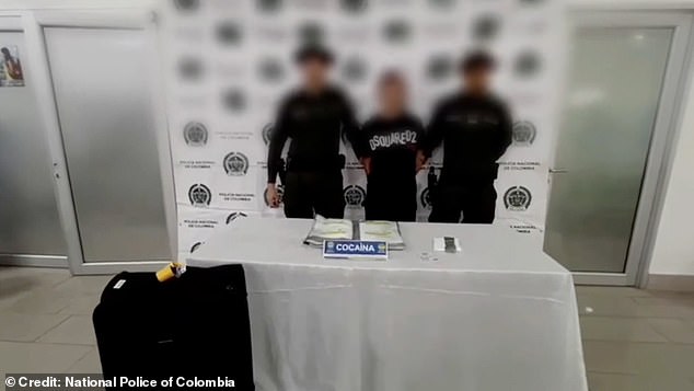 The Briton was forced to stand between two armed officers for his mugshot wearing an expensive T-shirt by designer Dsquared2 following the discovery of the drugs.