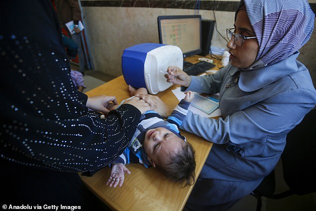 A baby receiving treatment at the UN agency's center. UK government figures have joined international condemnation of Israel after the Knesset voted to ban UNRWA from operating in Gaza.