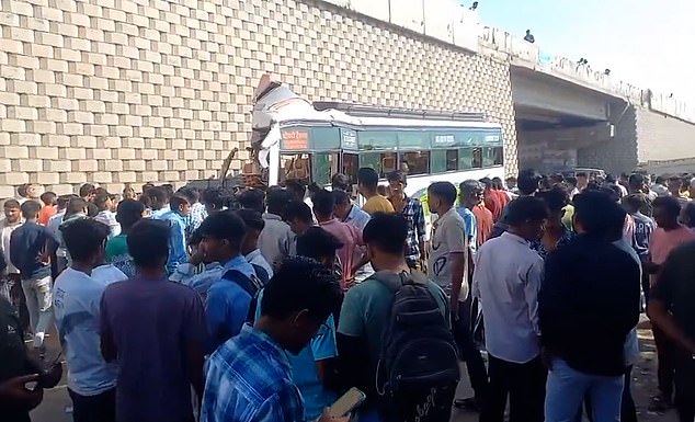 A crowd gathers around the rubble following the accident today in the Sikar district of Rajasthan in India.