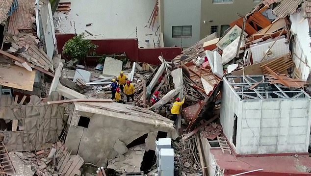 Rescuers search through the rubble for people believed to still be trapped.