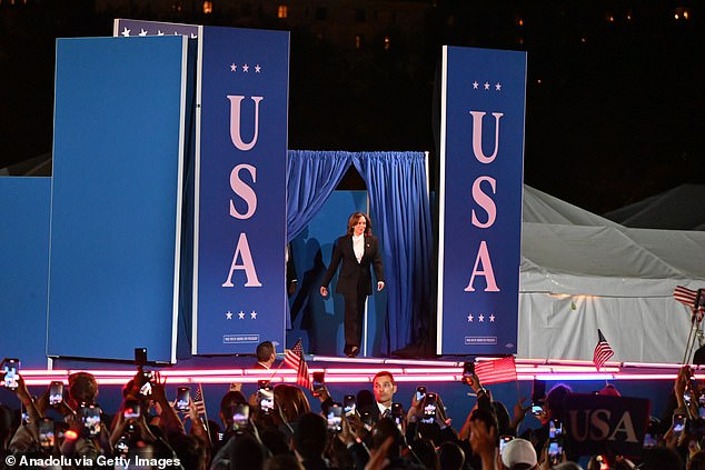 Harris makes her entrance on stage in front of thousands of people as helicopters fly overhead