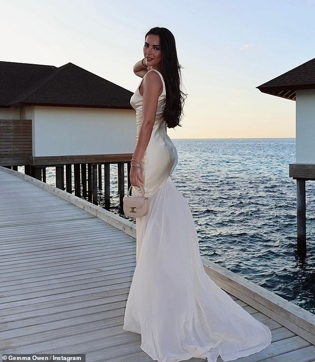 Gemma wowed in a gold dress as she posed on the beach at sunset for the group photo before taking a solo one by the water.