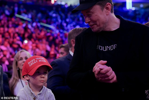 During Donald Trump's Sunday rally at Madison Square Garden in New York City, Elon Musk smiles at his son, who is wearing an oversized custom MAGA hat that reads: 