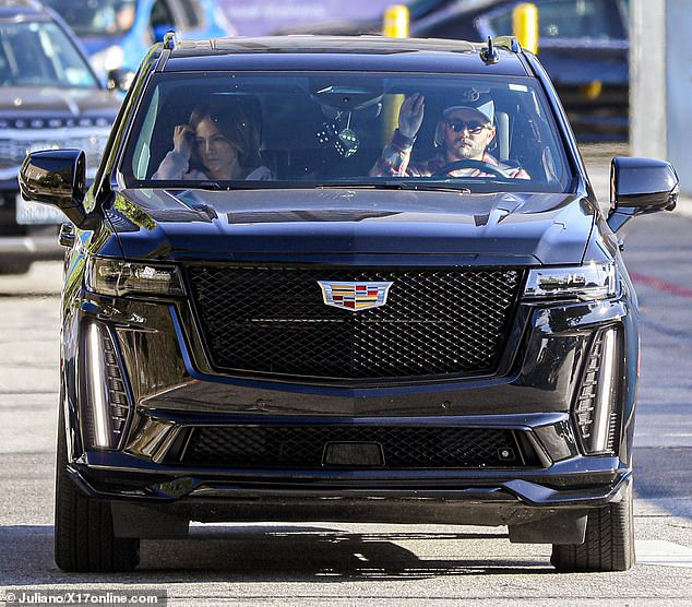 The mother-of-two opted to wear her brown hair in a sleek bun and a zip-up hoodie as she ran errands while being driven by a man driving a black Escalade.