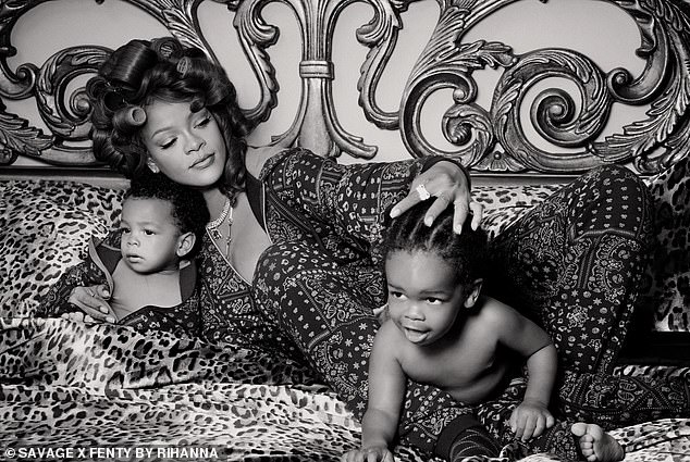 The trio donned navy paisley-print rompers for the cute shoot as they lay on a plush bed with leopard-print sheets.