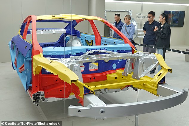 The interior construction of the body of the Xiaomi SU7 (pictured). An X user referred to the car as a 'Temu Tesla'