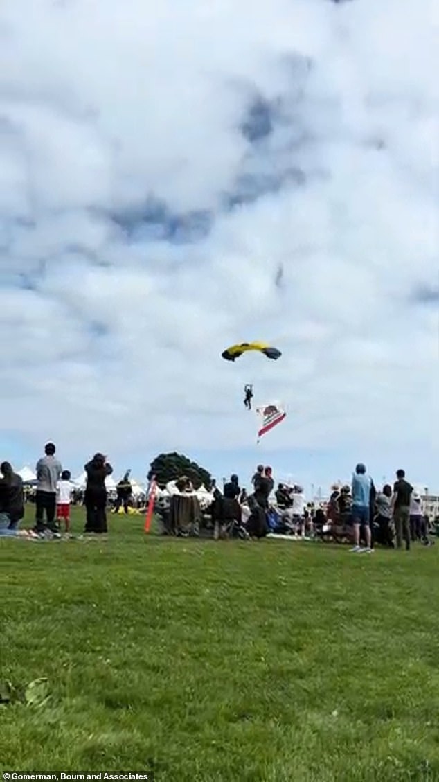 Another point of view shows the skydiver about to land in the crowd.