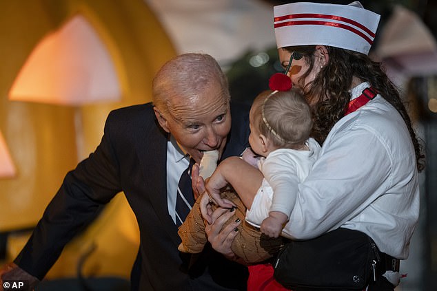 The president bites a baby's fingers