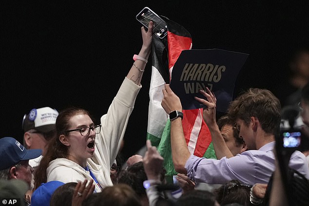 A protester with a Palestinian flag is removed while Harris spoke at her campaign event in Harrisburg, Pennsylvania.