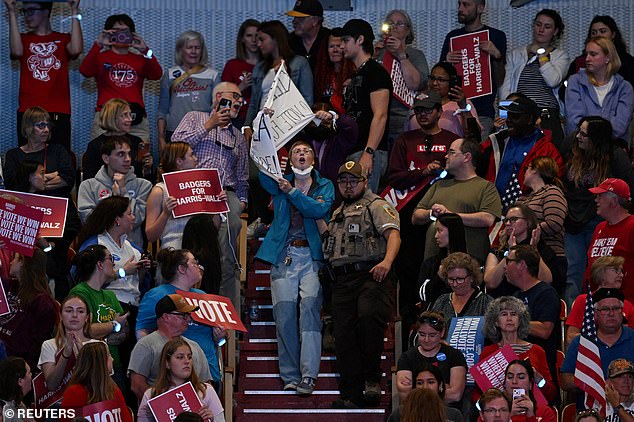 A protester is removed by security from the vice president's rally in Madison, WI.