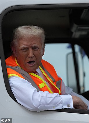 Former President Donald Trump speaks to reporters while sitting in a garbage truck on Wednesday, Oct. 30, 2024, in Green Bay, Wisconsin.