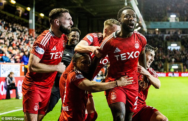 Morris celebrates with delirious teammates as Dons' incredible season continues apace